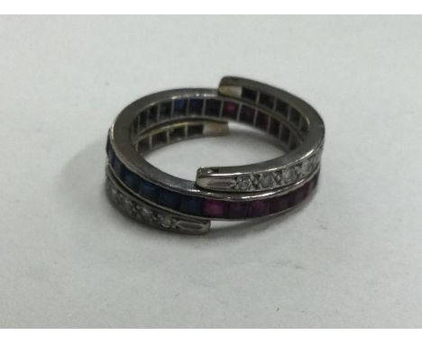 A good platinum mounted sapphire, ruby and diamond night and day ring. Approx. 9 grams. Est. £400 - £500.