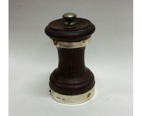 A mahogany and silver mounted pepper grinder of typical form. Est. £20 - £30.