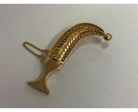 A high carat gold brooch in the form of a dagger. Approx. 7 grams. Est. £80 - £120.
