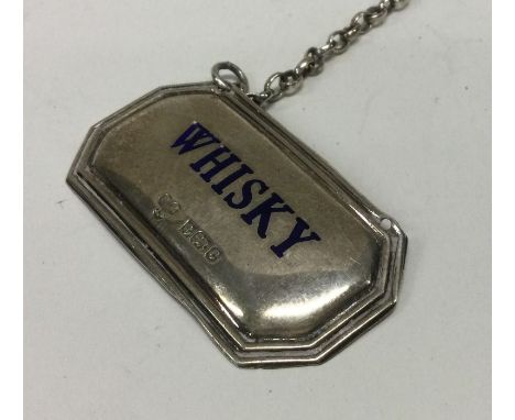 A rare silver and enamel wine label for ‘Whisky’. Birmingham 1977. By Peter Gilmore Ltd. Approx. 11 grams. Est. £50 - £80.