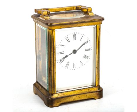 A brass-cased carriage clock, white enamel dial with Roman numeral hour markers, blued steel hands and bevelled-glass exhibit