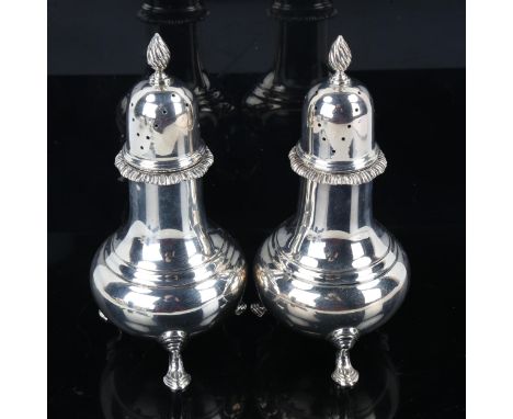 HARRODS - a pair of Elizabeth II silver pepperettes, baluster form with spiral finial and gadrooned rim, by Harrods Ltd, hall