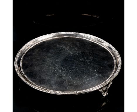 A George III circular silver salver, bead edge with engraved crest and motto "Touch Not The Cat Without A Glove", by Elizabet