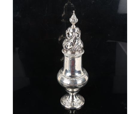 A heavy gauge George V silver sugar caster, baluster form with acanthus spiral finial and relief embossed decoration, by Jay,