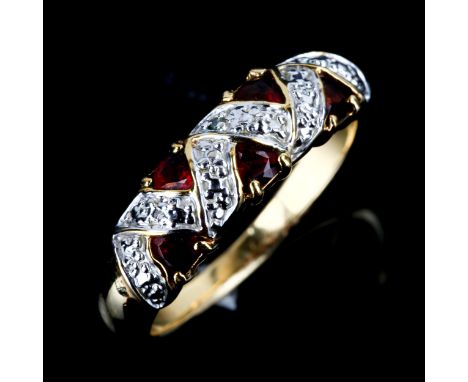 A modern garnet dress ring, unmarked yellow metal settings test as 9ct gold with trillion-cut garnets, setting height 6.4mm, 