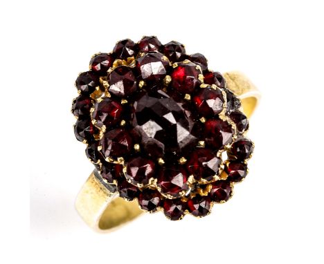 A Victorian Bohemian garnet cluster ring, unmarked gilt-metal settings with rose and facet-cut garnets, setting height 19.1mm
