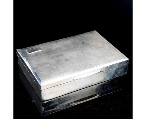 A George V silver cigarette box, rectangular form with engine turned decoration, by Harman Brothers, hallmarks Birmingham, 16