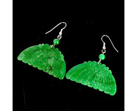 A pair of Art Deco carved jade panel drop earrings, unmarked white metal settings with shepherd hook fittings, overall height