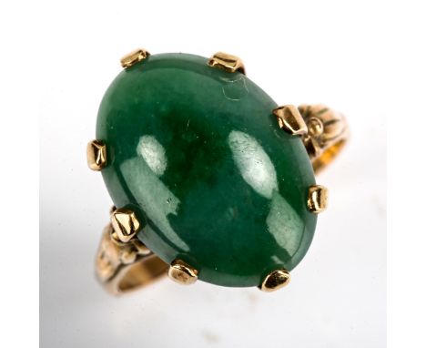 A late 20th century Chinese 14ct gold jade ring, set with oval cabochon jade, jade measures 15.83mm x 11.77mm x 4.56mm, size 