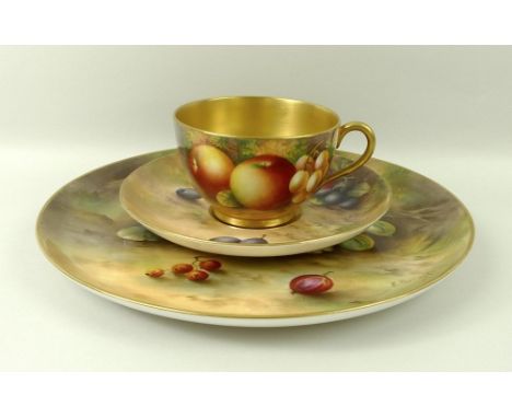 A Royal Worcester cabinet plate, decorated with plums and gooseberries, 23cm, and a tea cup and saucer, decorated with apples