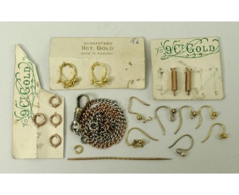 A gold and white metal chain and various earring fittings.