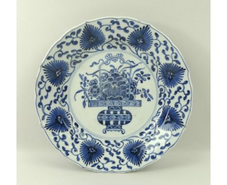 A Chinese porcelain blue and white dish, possibly Kangxi period, with lappet moulded rim, decorated in underglaze blue with a