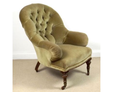 A button back armchair with turned and carved legs, raised on brown castors, 75 by 88 by 91cm high.
