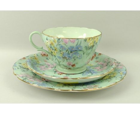 A Shelley part tea service in the Melody pattern, comprising six tea cups, saucers, and tea plates, milk jug, sugar bowl, and