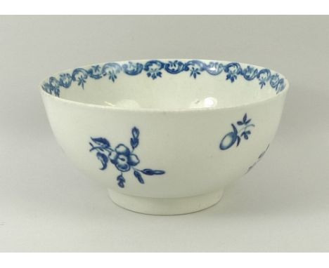 A first period Worcester bowl, circa 1770, with under glaze cobalt blue sprigs, blue crescent mark to the base, and high foot