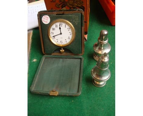 Two silver pepperettes and an eight day Swiss travelling clock. 