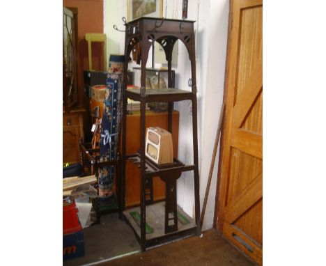 A large Arts and Crafts oak free standing three tier tapering square hall stand.  With an open shelf above a galleried platfo