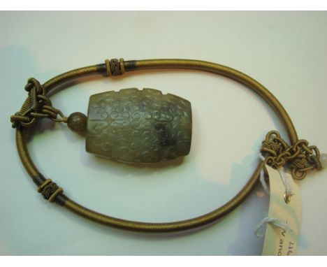 A large Chinese nephrite jade pendant necklace, all over carved with scrolling clouds. 