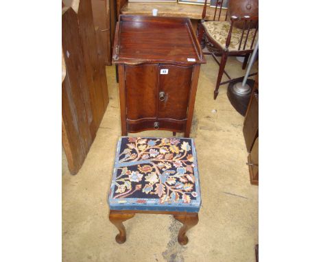 A George III style mahogany concave fronted pot cupboard, the top with three quarter gallery over a pair of cupboard doors an
