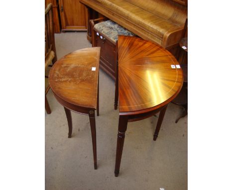 A reproduction mahogany demi lune pier table with open shelf raised on reeded tapering legs together with another smaller mah