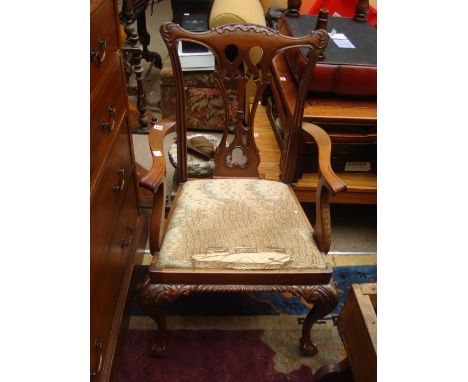 A reproduction Chippendale style mahogany armchair, with drop in seat raised on acanthus carved cabriole legs, with ball and 