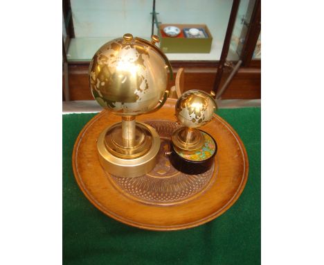 A globe cigarette lighter with musical movement together with a musical cigarette container in the form of a globe (both made