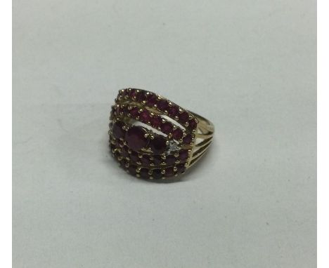A large ruby an diamond mounted cluster ring set in 9 carat. Approx. 6 grams. Est. £50 - £80.