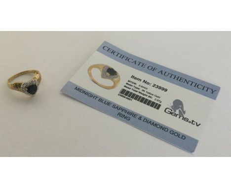 A sapphire and diamond ring set in 9 carat. Approx. 2.97 grams. Est. £25 - £35.