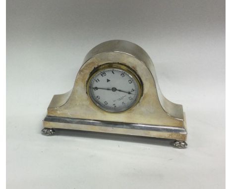 A silver mounted mantle clock with white enamelled dial and arched top. Approx. 571 grams. Est. £40 - £60.