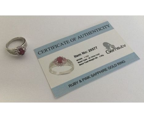 A ruby and pink sapphire ring set in 9 carat white gold. Approx. 2.86 grams. Est. £25 - £35.