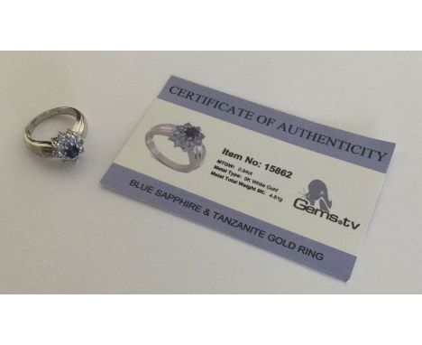 A sapphire and tanzanite ring set in 9 carat white gold. Approx. 4.61 grams. Est. £25 - £35.