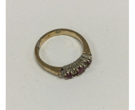 A 9 carat ruby and diamond seven stone ring. Approx. 2 grams. Est. £30 - £40.