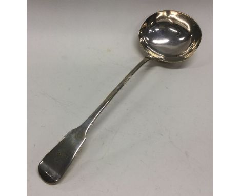 A large fiddle pattern silver soup ladle. London. By WC. Approx. 103 grams. Est. £50 - £80.