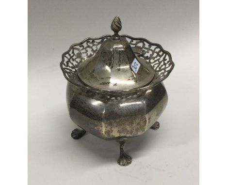 An Edwardian silver hinged top tea caddy with pierced rim. Chester. Approx. 200 grams. Est. £60 - £80.