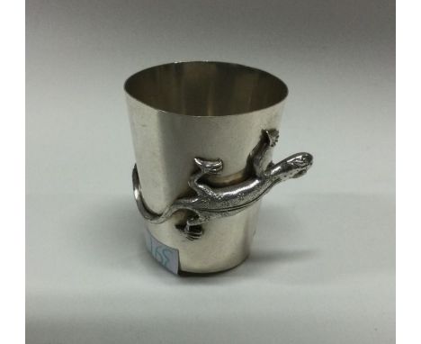 A Chinese chased silver cup decorated with lizards and spider. Approx. 16 grams. Est. £50 - £80.