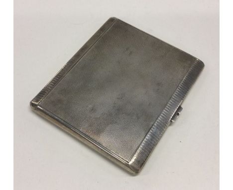 A heavy engine turned silver cigarette case. Approx. 145 grams. Est. £30 - £40.