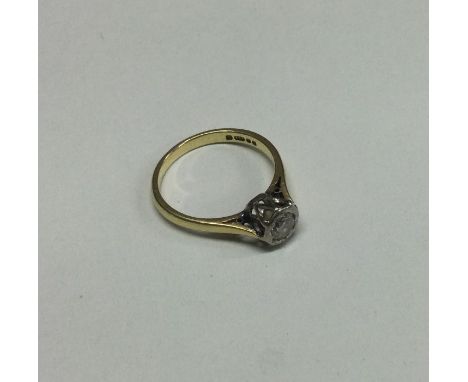 An 18 carat gold diamond mounted single stone ring. Approx. 3 grams. Est. £80 - £120.