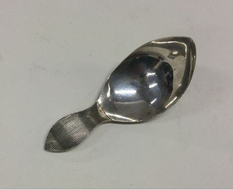 An Antique Dutch silver caddy spoon of hammered design. Approx. 34 grams. Est. £50 - £80.