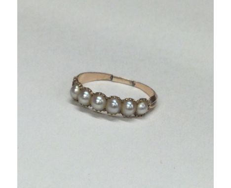 An Antique pearl seven stone ring in claw mount. (One pearl missing). Approx. 2 grams. Est. £30 - £50.