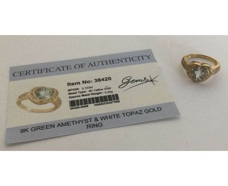 A green amethyst and white topaz ring set in 9 carat. Approx. 3.33 grams. Est. £25 - £35.