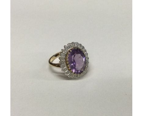 A small amethyst and diamond cluster ring in 9 carat mount. Approx. 5 grams. Est. £40 - £60.