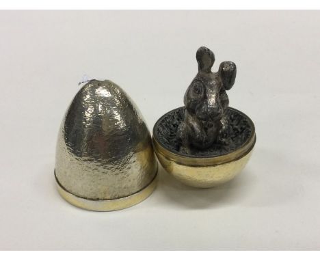 STUART DEVLIN: A silver 'surprise' egg cast with a rabbit. London 1973. Approx. 181 grams. Est. £350 - £450.