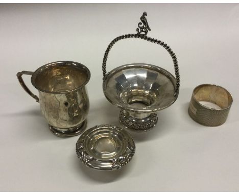 A small silver christening cup, napkin ring etc. Various dates and makers. Approx. 217 grams. Est. £30 - £50.