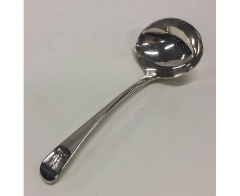 A Georgian silver OE pattern sauce ladle with crested terminal. London. By GS. Approx. 44 grams. Est. £30 - £50.