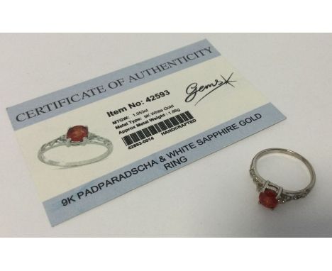 A padparadscha and white sapphire ring set in 9 carat white gold. Approx. 1.86 grams. Est. £25 - £35.