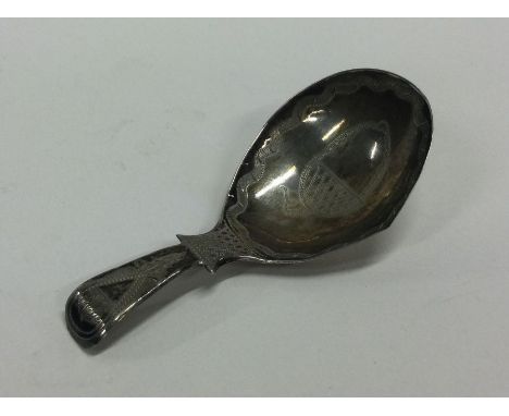 A good Georgian silver bright cut caddy spoon. Birmingham. By TT. Approx. 8 grams. Est. £40 - £60.