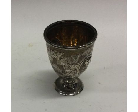 A good quality Victorian silver egg cup decorated with figures. London. By JA. Approx. 61 grams. Est. £30 - £50.