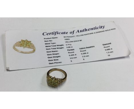 A peridot, yellow sapphire &amp; diamond ring set in 9 carat. Approx. 3.74 grams. Est. £25 - £35.