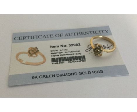 A green diamond cluster ring set in 9 carat. Approx. 2.24 grams. Est. £25 - £35.