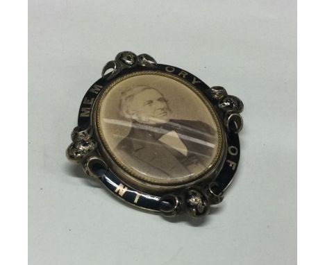 A large gold mourning brooch with enamel decoration to hair back. Approx. 53 grams. Est. £200 - £300.